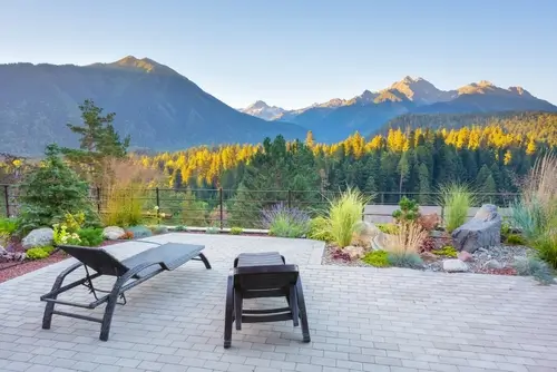 Modern backyard patio with mountain view and outdoor seating