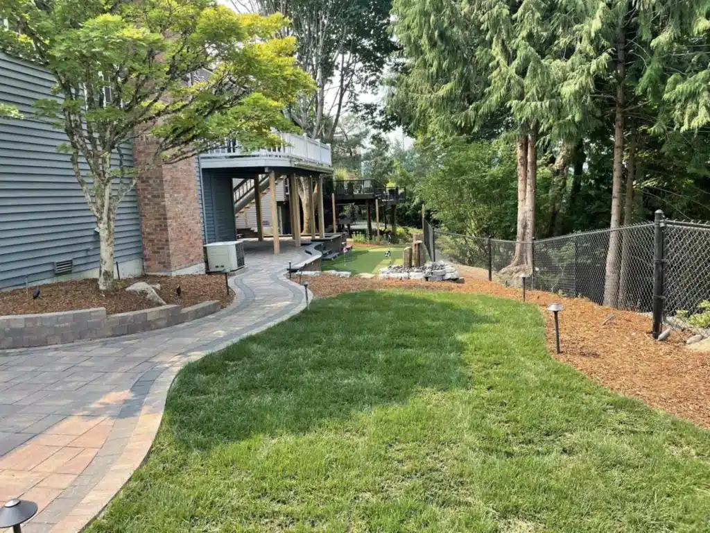 Landscape contractor discussing backyard design plans with homeowners